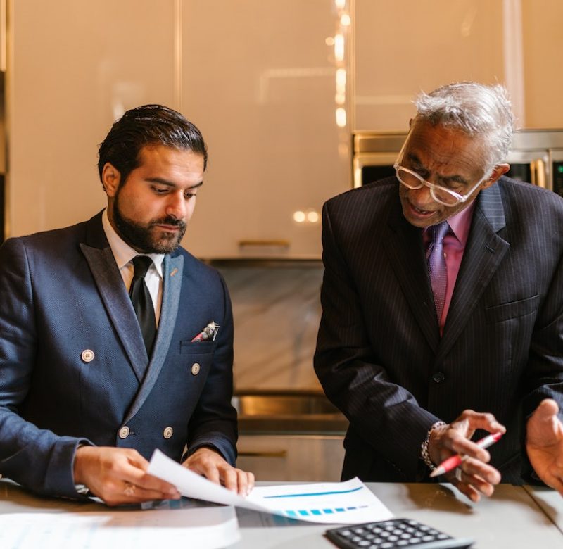 An wrongful death attorney explaining a document to a colleague