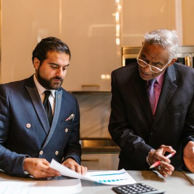An wrongful death attorney explaining a document to a colleague